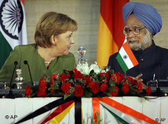 Indian Prime Minister Manmohan Singh, right, talks with German Chancellor Angela Merkel