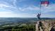 Man posing with Frankish flag on Staffelberg near Bad Staffelstein in Bavaria