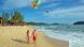 Tourists walk on Cenang beach on the island of Langkawi.