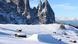 Snow covered valley with cattle feeding huts in Val Gardena, Italy