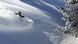 A skier going through deep snow on a slope in Baqueira-Beret, Spain 