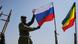 A Malian soldier holds a Russian flag