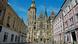 Frontal view of St. Elisabeth Cathedral, framed by historic buildings on either side.