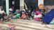 A group of displaced people sitting on some steps in Bunagana, Uganda