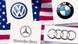 Montage of German carmaker logos on a US flag